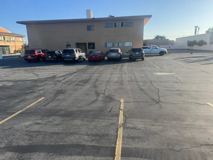 Parked cars along the fellowship building at the edge of the church parking lot