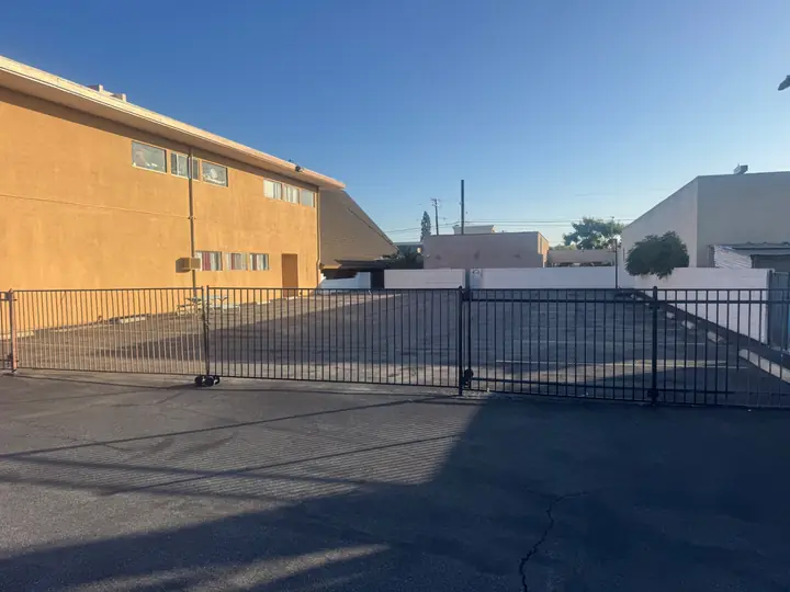 Black metal gate at the entrance to the church parking lot