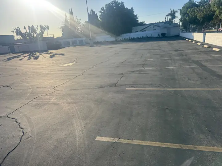 Open striped parking area on the church campus in afternoon light