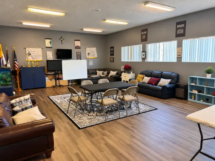 Second view of the lounge meeting room with sofas, shelving and a meeting table