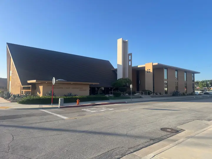 Corner street view of the Norwalk Seventh-day Adventist Church building and bell tower