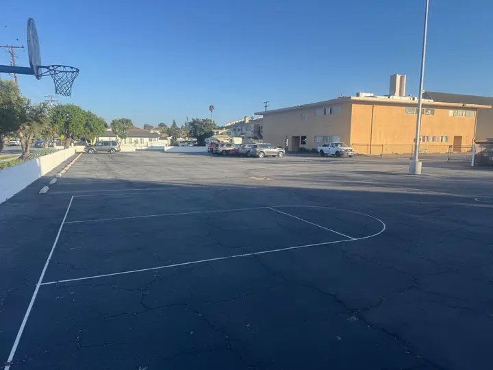 Paved basketball court and additional parking spaces on the church campus