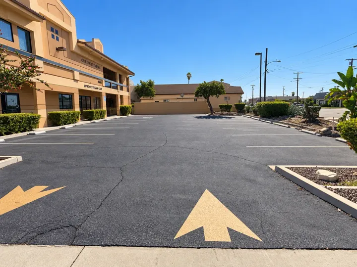 Parking lot entrance beside the Norwalk Events Center building with painted direction arrows