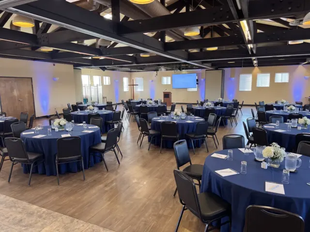 AI design concept of the hall set for a conference with blue linens, a screen and a podium