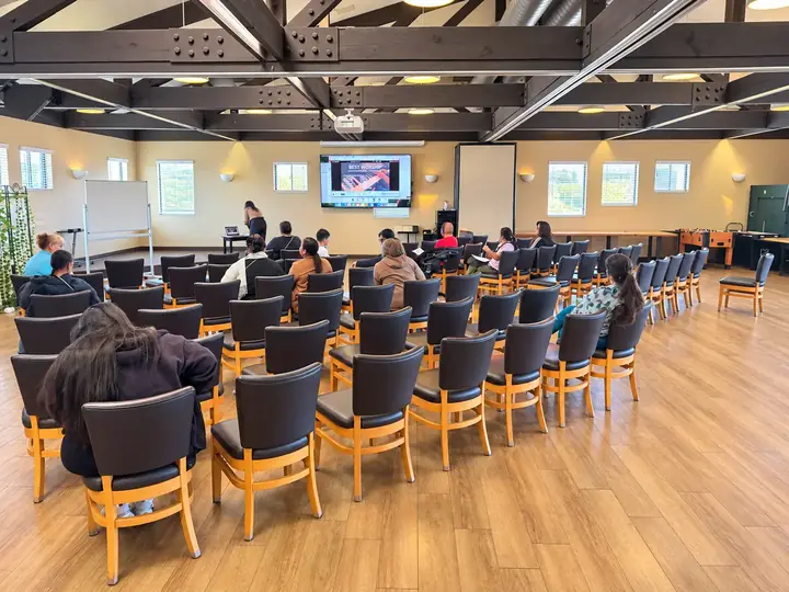 Fellowship hall arranged in theater rows facing a presentation screen